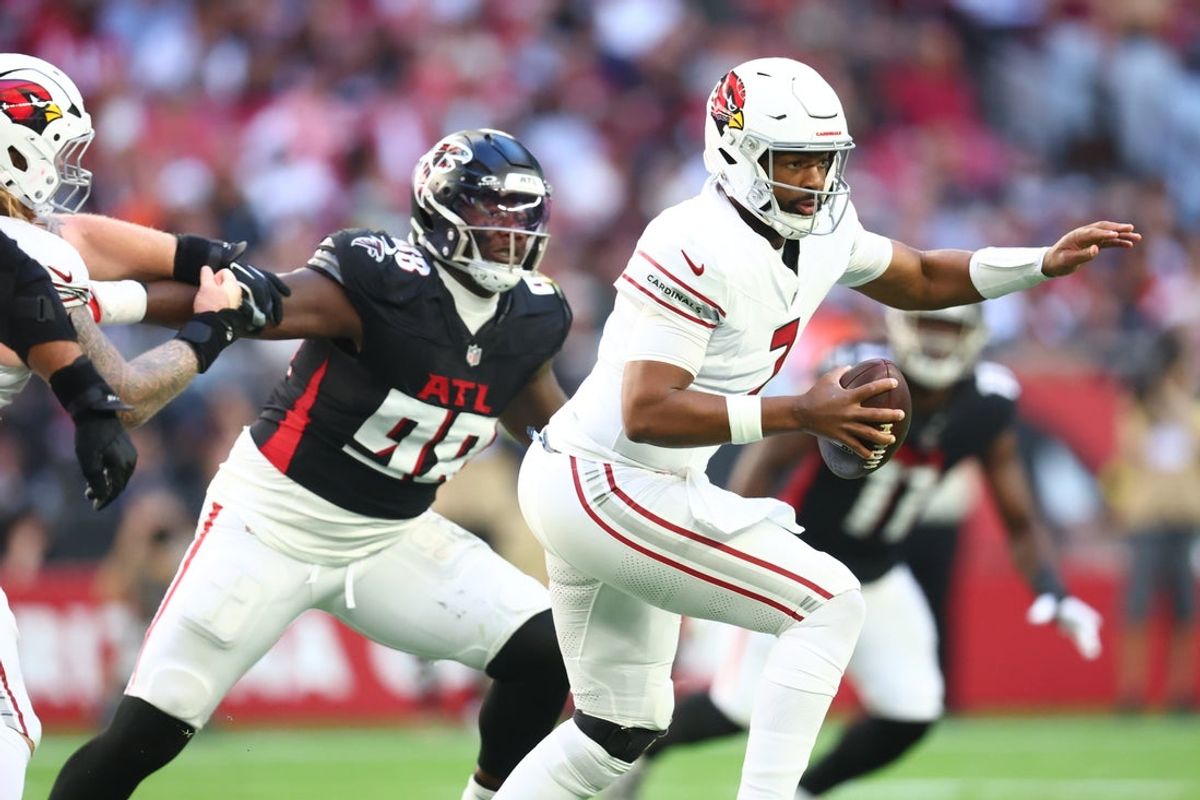 Dec 21, 2025; Glendale, Arizona, USA;  Arizona Cardinals quarterback Jacoby Brissett (7) is pressured by. Atlanta Falcons defensive tackle Ruke Orhorhoro (98) during the first half at State Farm Stadium. Mandatory Credit: Mark J. Rebilas-Imagn Images