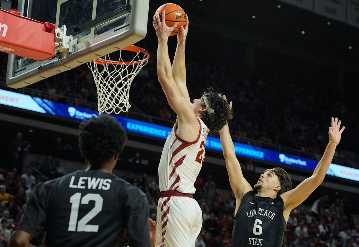Iowa State Cyclones forward Blake Buchanan (23) goes for dunk the ball around Long Beach State forward Petar Majstorovic (6) and guard Isaiah Lewis (12) during the first half in the NCAA men’s basketball on Dec. 21, 2025, at Hilton Coliseum in Ames, Iowa.