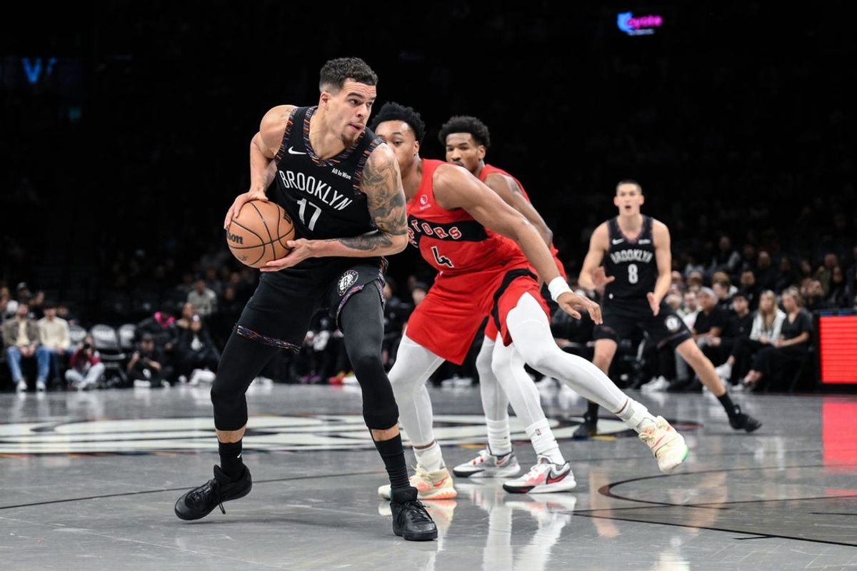 Dec 21, 2025; Brooklyn, New York, USA; Brooklyn Nets forward Michael Porter Jr. (17) tries to get past Toronto Raptors forward/guard Scottie Barnes (4) during the first half at Barclays Center. Mandatory Credit: John Jones-Imagn Images