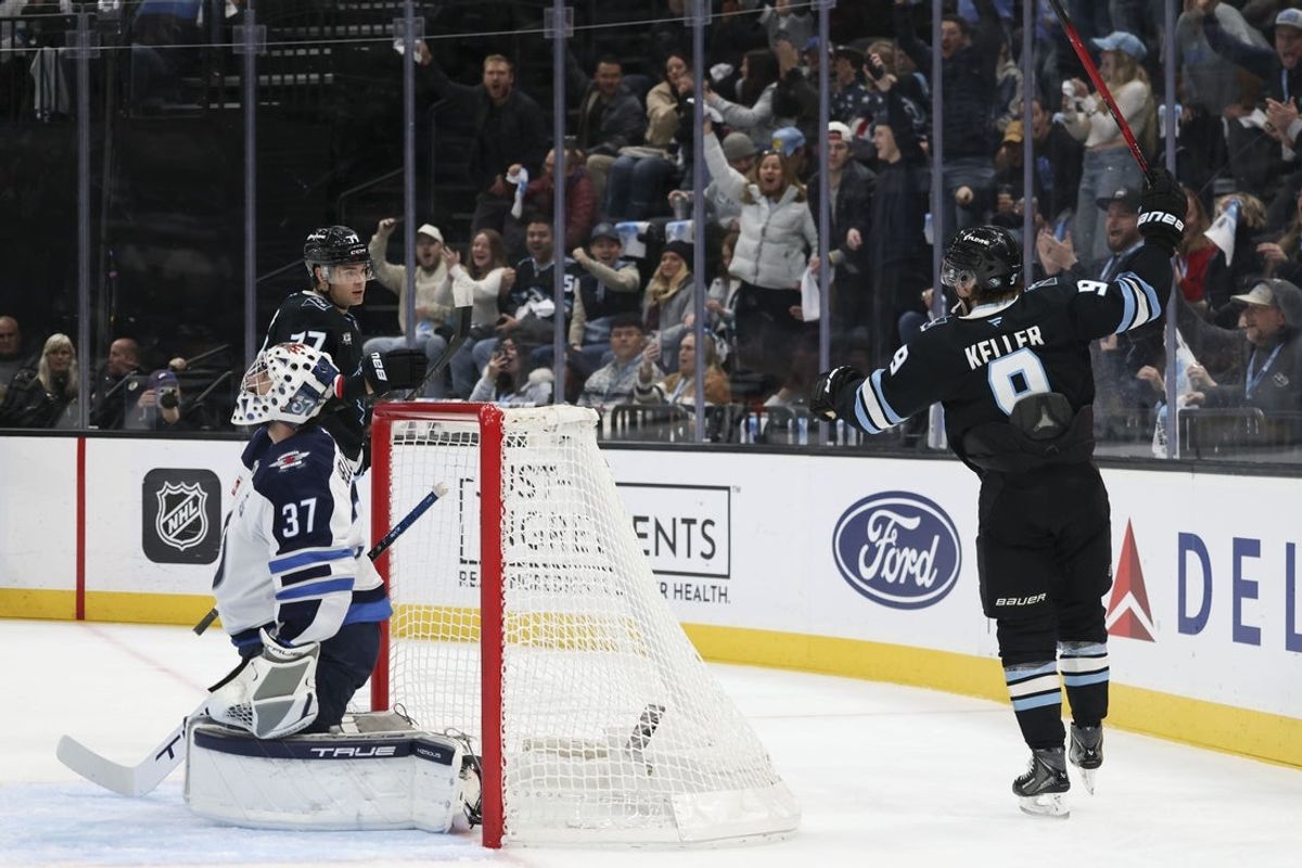 Dec 21, 2025; Salt Lake City, Utah, USA; Utah Mammoth right wing JJ Peterka (back) celebrates a goal against the Winnipeg Jets with right wing Clayton Keller (9) during the first period at Delta Center. Mandatory Credit: Rob Gray-Imagn Images