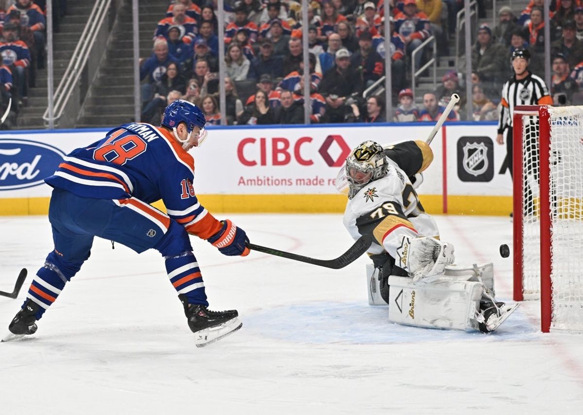 Dec 21, 2025; Edmonton, Alberta, CAN; Edmonton Oilers left winger Zach Hyman (18) tries to get a shot past Vegas Golden Knights goalie Carter Hart (79) during the first period at Rogers Place. Mandatory Credit: Walter Tychnowicz-Imagn Images