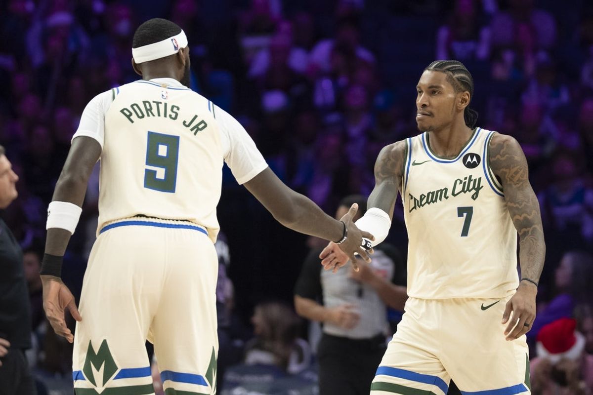 Dec 21, 2025; Minneapolis, Minnesota, USA; Milwaukee Bucks guard Kevin Porter Jr. (7) celebrates with Milwaukee Bucks forward Bobby Portis (9) after making a shot against the Minnesota Timberwolves in the second half at Target Center. Mandatory Credit: Jesse Johnson-Imagn Images