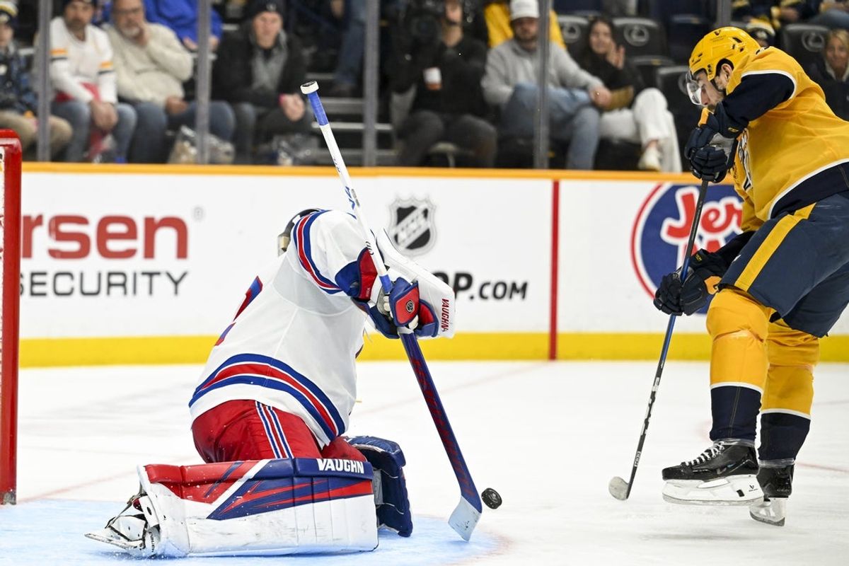 Dec 21, 2025; Nashville, Tennessee, USA;  New York Rangers goaltender Jonathan Quick (32) blocks the shot of Nashville Predators left wing Filip Forsberg (9) during the third period at Bridgestone Arena. Mandatory Credit: Steve Roberts-Imagn Images