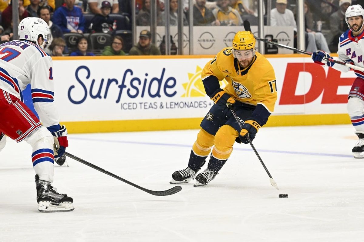 Dec 21, 2025; Nashville, Tennessee, USA;  Nashville Predators center Tyson Jost (17) skates with the puck against the New York Rangers during the third period at Bridgestone Arena. Mandatory Credit: Steve Roberts-Imagn Images