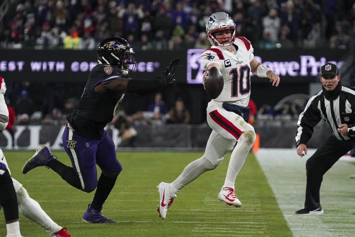 Dec 21, 2025; Baltimore, Maryland, USA;  Baltimore Ravens linebacker Roquan Smith (0) pushes New England Patriots quarterback Drake Maye (10) out of bounds during the second half of the game at M&T Bank Stadium. Mandatory Credit: James Lang-Imagn Images