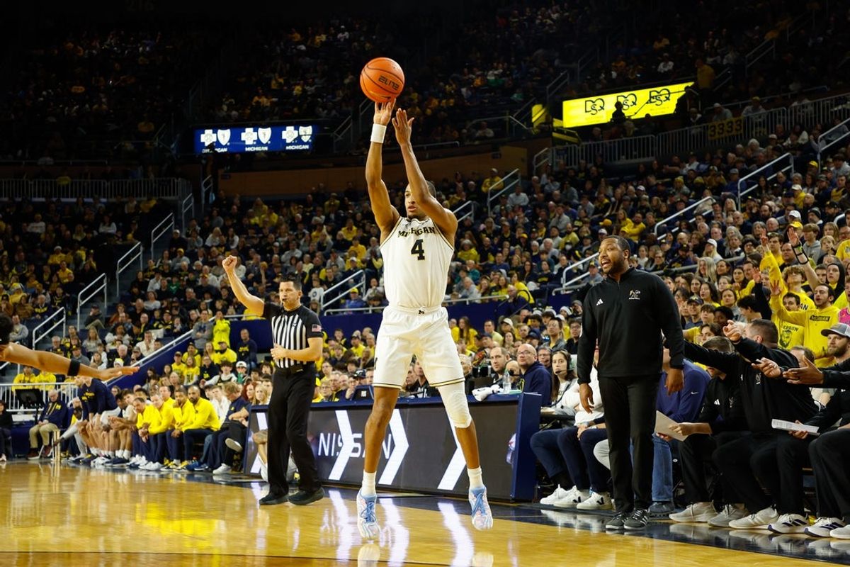 Dec 21, 2025; Ann Arbor, Michigan, USA; Michigan Wolverines guard Nimari Burnett (4) shoots a three point shot during the first half against the La Salle Explorers at Crisler Center. Mandatory Credit: Brian Bradshaw Sevald-Imagn Images
