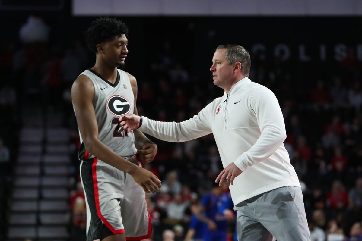 Dec 22, 2025; Athens, Georgia, USA; Georgia Bulldogs head coach Mike White talks to Georgia Bulldogs forward Jake Wilkins (21) against the West Georgia Wolves in the second half at Stegeman Coliseum. Mandatory Credit: Mady Mertens-Imagn Images