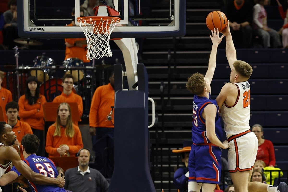 Dec 22, 2025; Charlottesville, Virginia, USA; Virginia Cavaliers forward Thijs De Ridder (28) shoots the ball over American University Eagles forward Matt Mayock (33) in the first half at John Paul Jones Arena. Mandatory Credit: Geoff Burke-Imagn Images