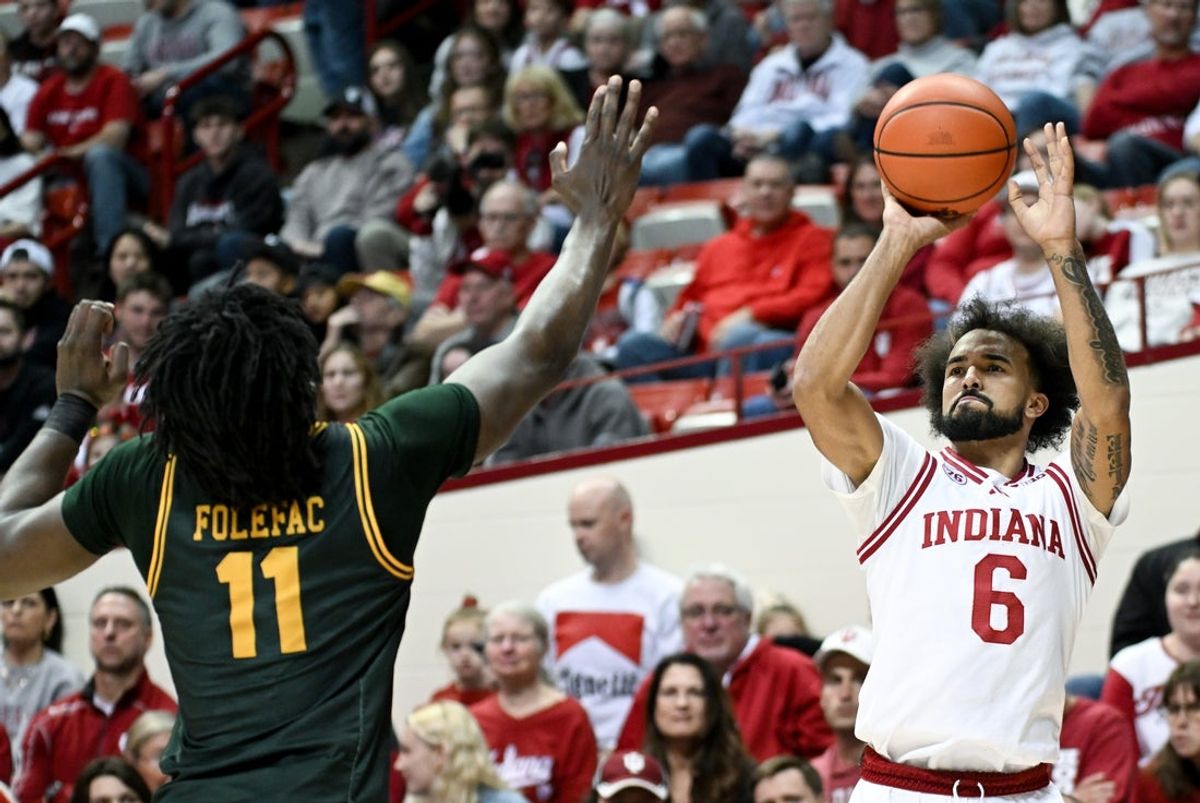 Dec 22, 2025; Bloomington, Indiana, USA; Indiana Hoosiers guard Tayton Conerway (6) shoots the ball over Siena Saints forward Francis Folefac (11) during the first half at Simon Skjodt Assembly Hall. Mandatory Credit: Robert Goddin-Imagn Images