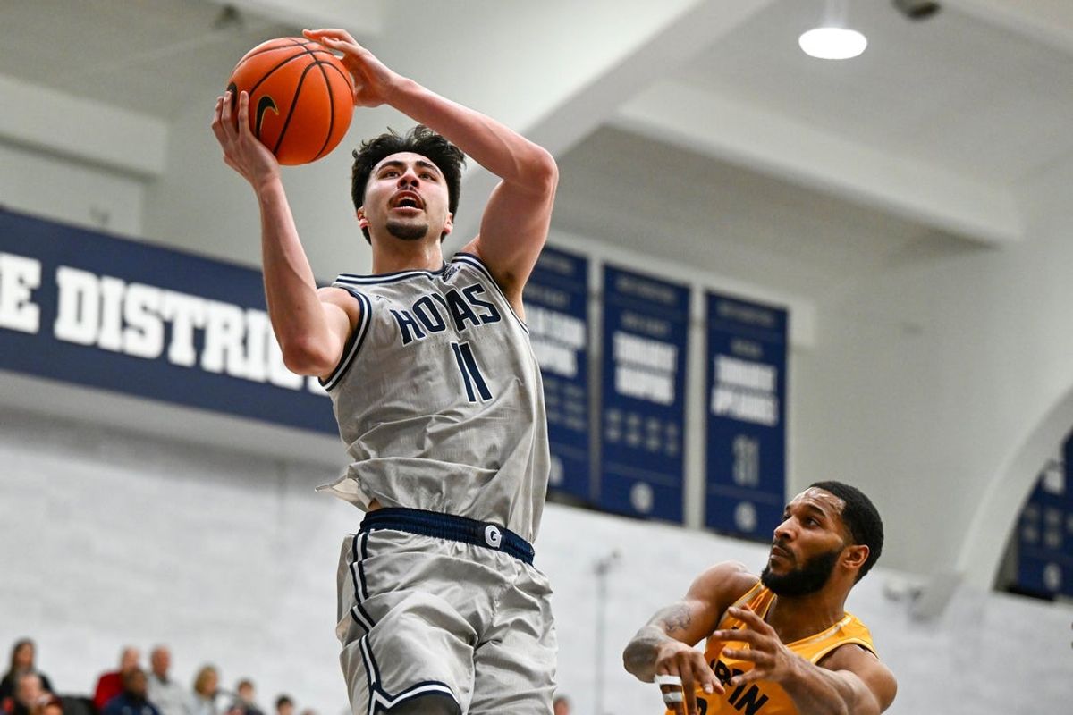 Dec 22, 2025; Washington, District of Columbia, USA; Georgetown Hoyas center Julius Halaifonua (11) shoots as Coppin State Eagles forward Taj Thweatt (24) defends during the first half at McDonough Arena. Mandatory Credit: Brad Mills-Imagn Images