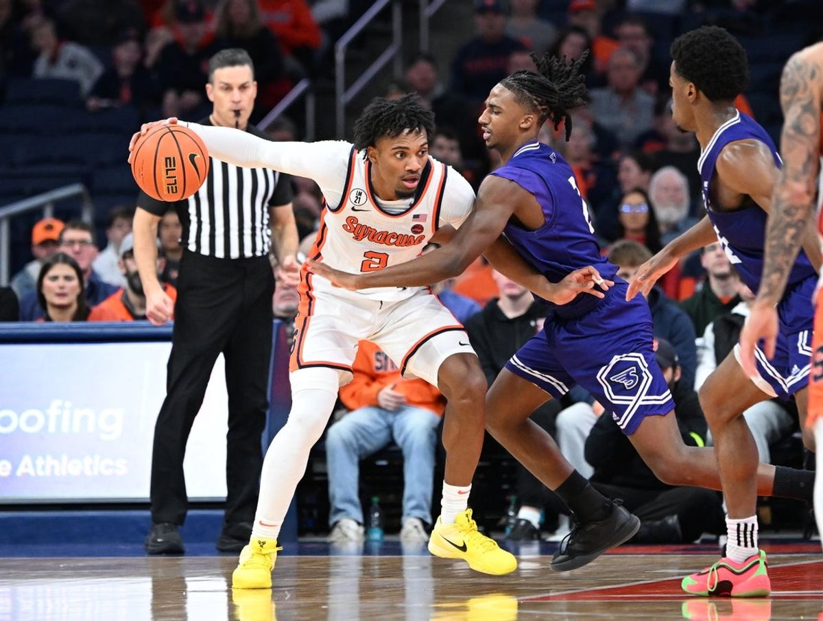 Dec 22, 2025; Syracuse, New York, USA; Syracuse Orange Guard J.J. Starling (2) handles the ball with Stonehill Skyhawks Guard Trenton Ruth (2) defending in the first half at the JMA Wireless Dome. Mandatory Credit: Mark Konezny-Imagn Images