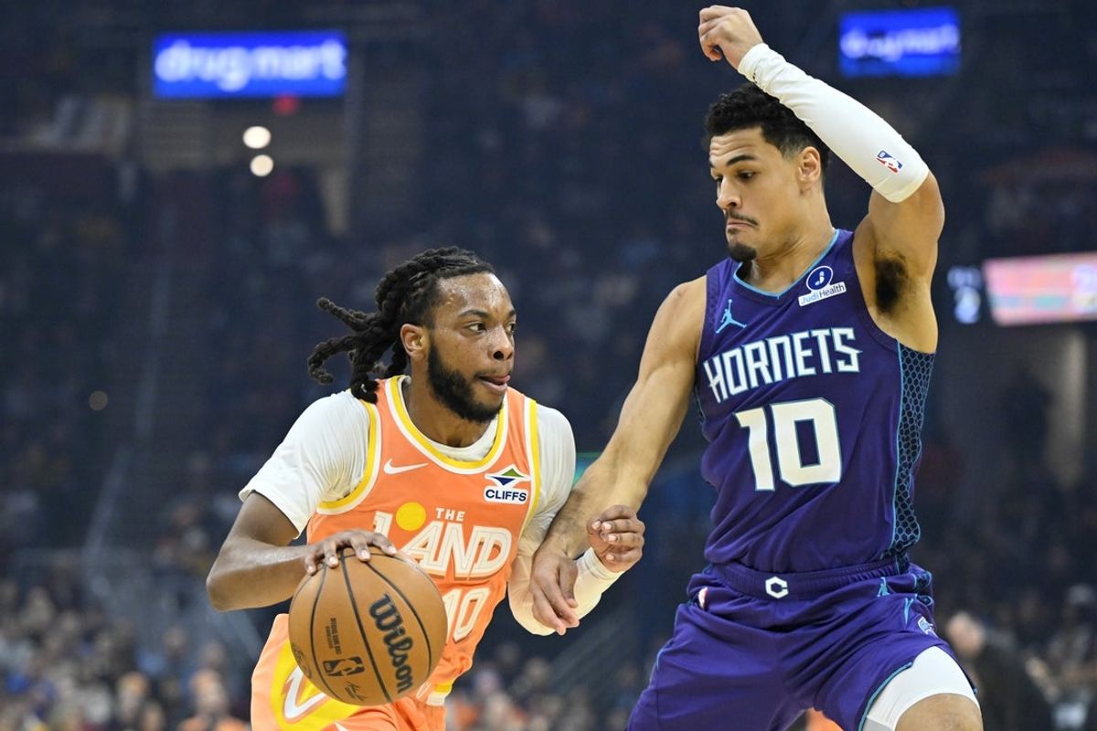 Dec 22, 2025; Cleveland, Ohio, USA; Cleveland Cavaliers guard Darius Garland (10) dribbles beside Charlotte Hornets guard Josh Green (10) in the first quarter at Rocket Arena. Mandatory Credit: David Richard-Imagn Images