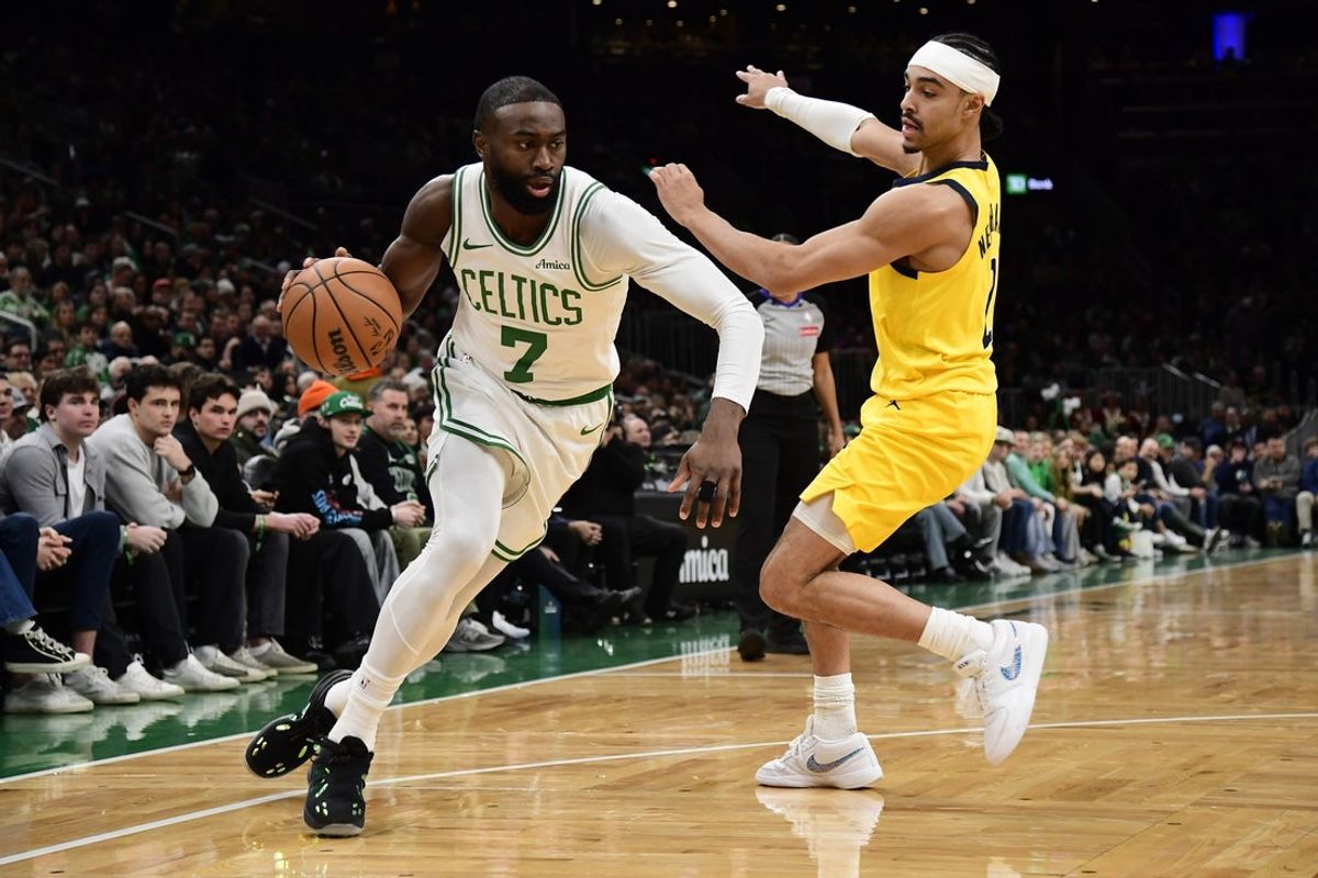 Dec 22, 2025; Boston, Massachusetts, USA;  Boston Celtics guard Jaylen Brown (7) controls the ball while Indiana Pacers guard Andrew Nembhard (2) defends during the second half at TD Garden. Mandatory Credit: Bob DeChiara-Imagn Images