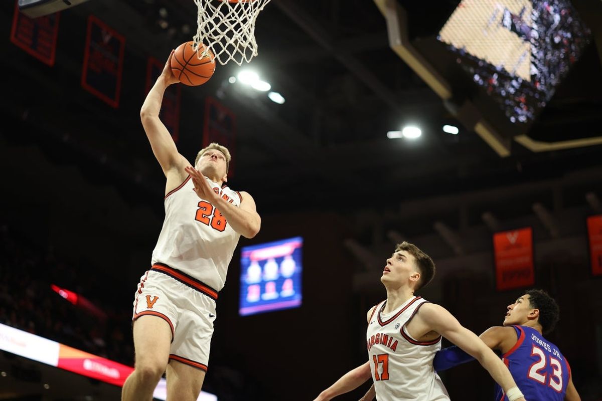 Dec 22, 2025; Charlottesville, Virginia, USA; Virginia Cavaliers forward Thijs de Ridder (28) dunks the ball as Cavaliers center Johann Grunloh (17) and American University Eagles forward Greg Jones (23) look on in the second half at John Paul Jones Arena. Mandatory Credit: Geoff Burke-Imagn Images