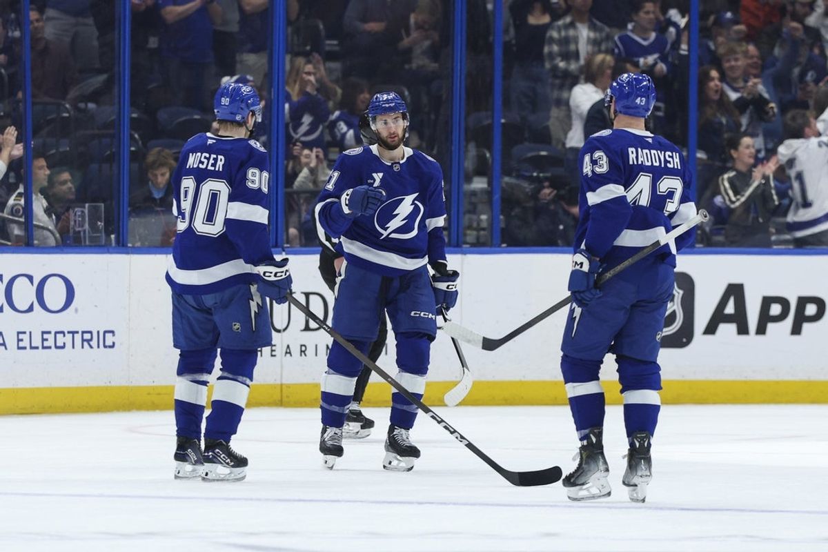 Dec 22, 2025; Tampa, Florida, USA; Tampa Bay Lightning center Anthony Cirelli (71) reacts with defenseman J.J. Moser (90) and defenseman Darren Raddysh (43) after scoring a goal against the St. Louis Blues in the second period at Benchmark International Arena. Mandatory Credit: Nathan Ray Seebeck-Imagn Images
