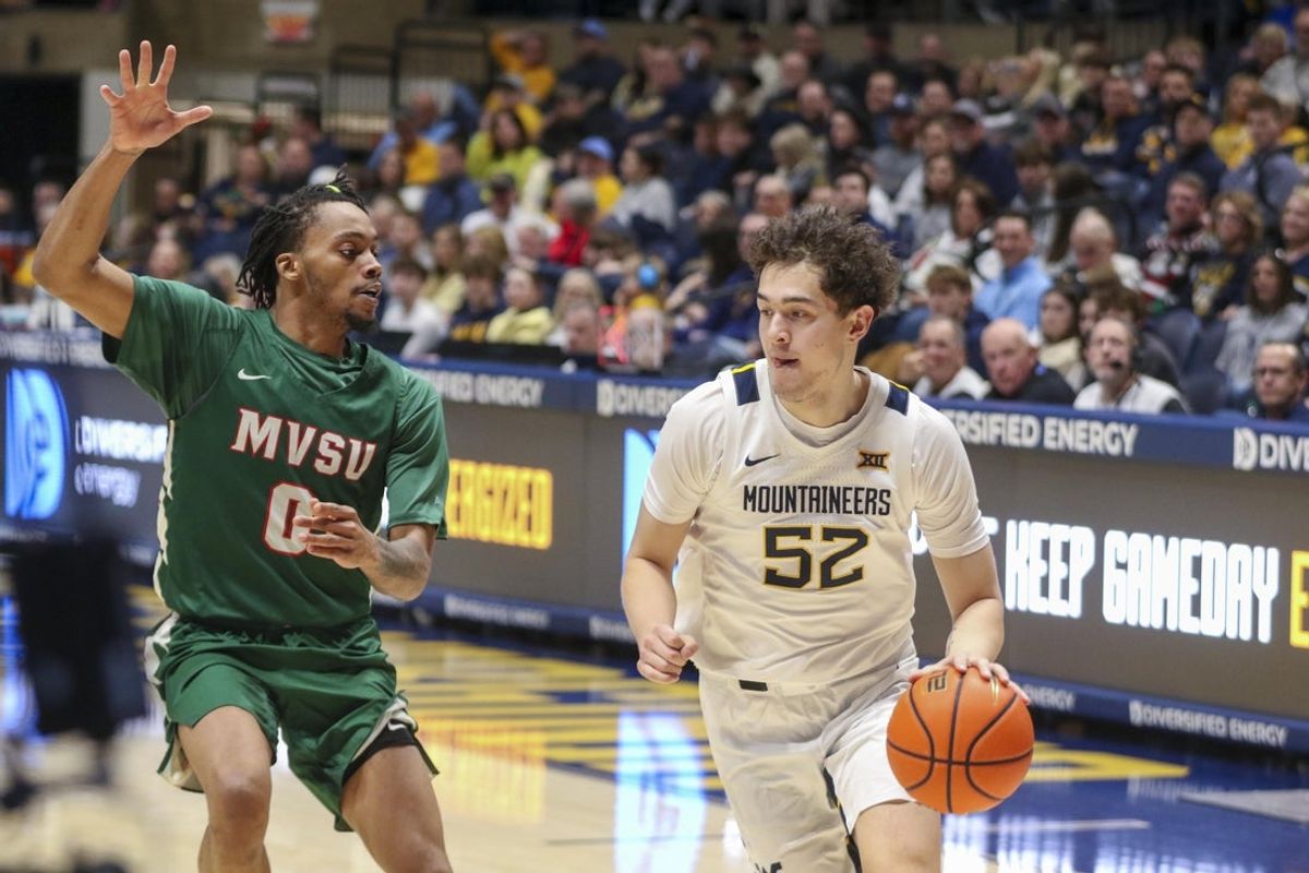 Dec 22, 2025; Morgantown, West Virginia, USA; West Virginia Mountaineers guard Treysen Eaglestaff (52) dribbles against Mississippi Valley State Delta Devils guard Patrick Punch (0) during the first half at Hope Coliseum. Mandatory Credit: Ben Queen-Imagn Images
