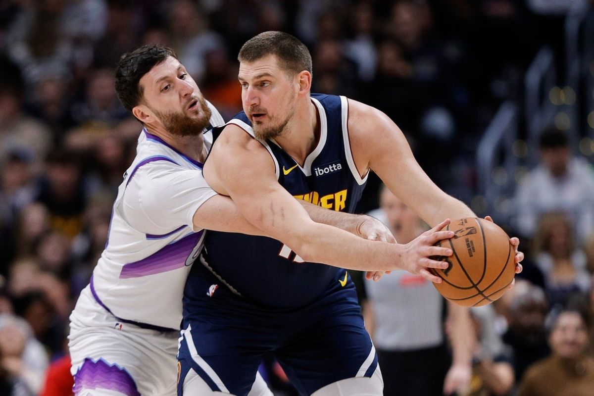 Dec 22, 2025; Denver, Colorado, USA; Denver Nuggets center Nikola Jokic (15) controls the ball under pressure from Utah Jazz center Jusuf Nurkic (30) in the first quarter at Ball Arena. Mandatory Credit: Isaiah J. Downing-Imagn Images