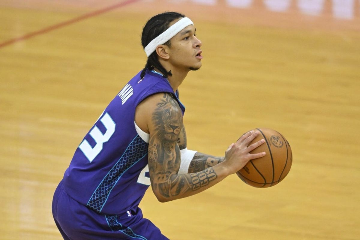 Dec 22, 2025; Cleveland, Ohio, USA; Charlotte Hornets guard Tre Mann (23) shoots in the third quarter against the Cleveland Cavaliers at Rocket Arena. Mandatory Credit: David Richard-Imagn Images