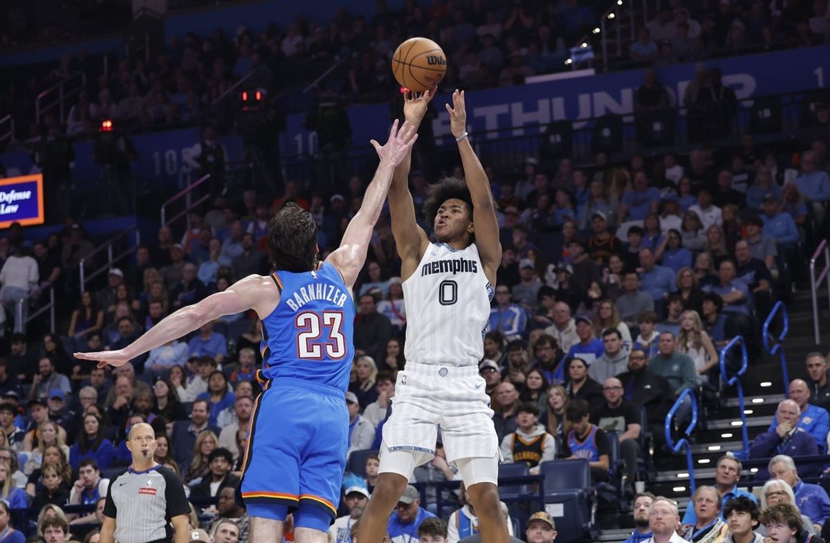 Dec 22, 2025; Oklahoma City, Oklahoma, USA; Memphis Grizzlies forward Jaylen Wells (0) shoots over Oklahoma City Thunder forward Brooks Barnhizer (23) during the second quarter at Paycom Center. Mandatory Credit: Alonzo Adams-Imagn Images