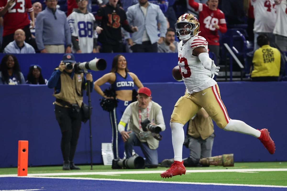 Dec 22, 2025; Indianapolis, Indiana, USA; San Francisco 49ers linebacker Dee Winters (53) carries the ball after an interception for a touchdown against the Indianapolis Colts in the fourth quarter of the game at Lucas Oil Stadium. Mandatory Credit: Trevor Ruszkowski-Imagn Images