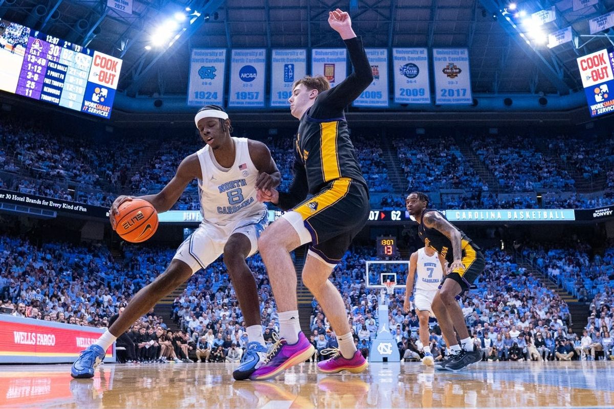 Dec 22, 2025; Chapel Hill, North Carolina, USA; North Carolina Tar Heels forward Caleb Wilson (8) spins on East Carolina Pirates forward Vito Perkovic (11) during the second half at Dean E. Smith Center. Mandatory Credit: Scott Kinser-Imagn Images