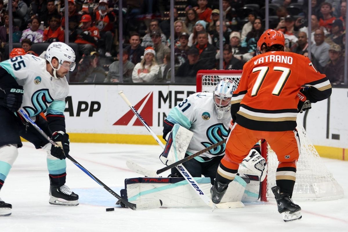 Dec 22, 2025; Anaheim, California, USA;  Seattle Kraken goaltender Philipp Grubauer (31) blocks a shot against Anaheim Ducks right wing Frank Vatrano (77) during the second period at Honda Center. Mandatory Credit: Kiyoshi Mio-Imagn Images