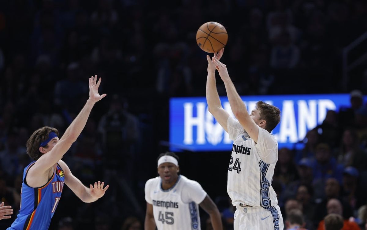 Dec 22, 2025; Oklahoma City, Oklahoma, USA; Memphis Grizzlies guard Cam Spencer (24) shoots as Oklahoma City Thunder center Branden Carlson (15) comes in to defend the shot during the second half at Paycom Center. Mandatory Credit: Alonzo Adams-Imagn Images