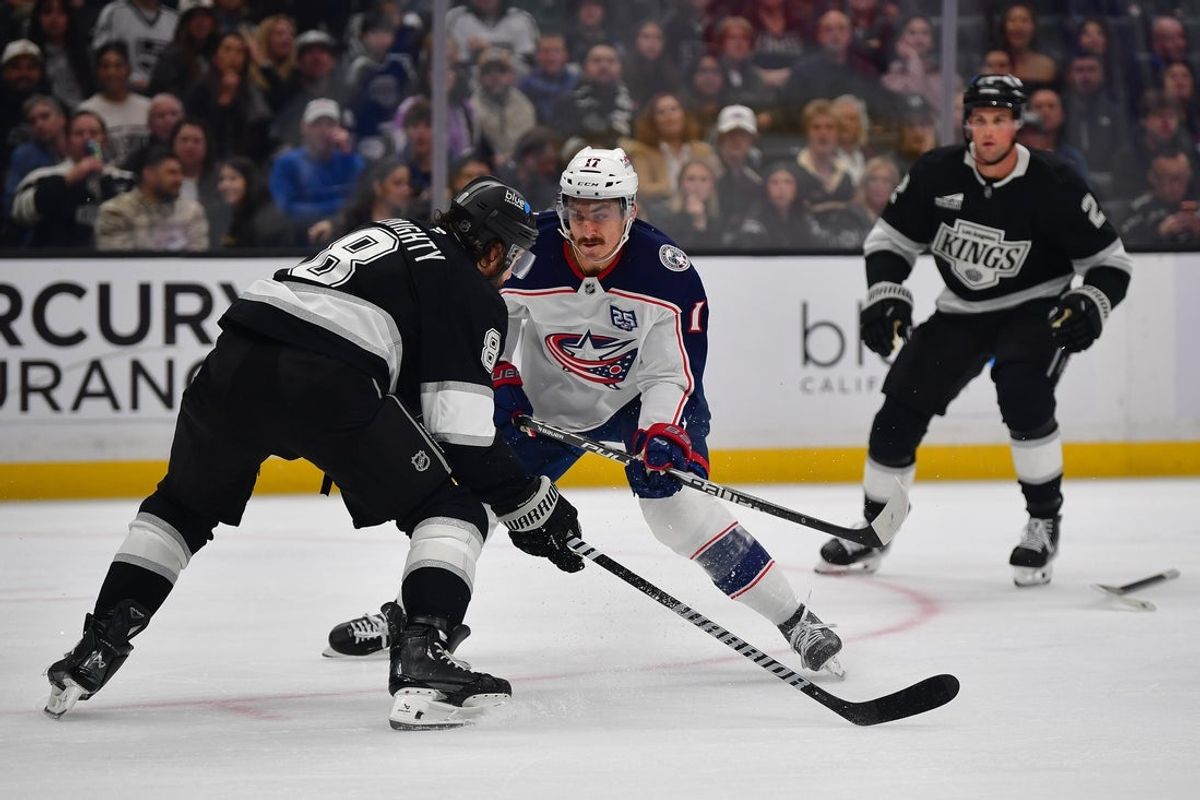 Dec 22, 2025; Los Angeles, California, USA; Columbus Blue Jackets left wing Mason Marchment (17) moves the puck against Los Angeles Kings defenseman Drew Doughty (8) during the third period at Crypto.com Arena. Mandatory Credit: Gary A. Vasquez-Imagn Images