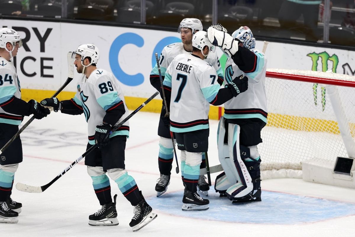 Dec 22, 2025; Anaheim, California, USA;  Seattle Kraken right wing Jordan Eberle (7) and goaltender Philipp Grubauer (right) celebrate a win after defeating the Anaheim Ducks 3-1 at Honda Center. Mandatory Credit: Kiyoshi Mio-Imagn Images