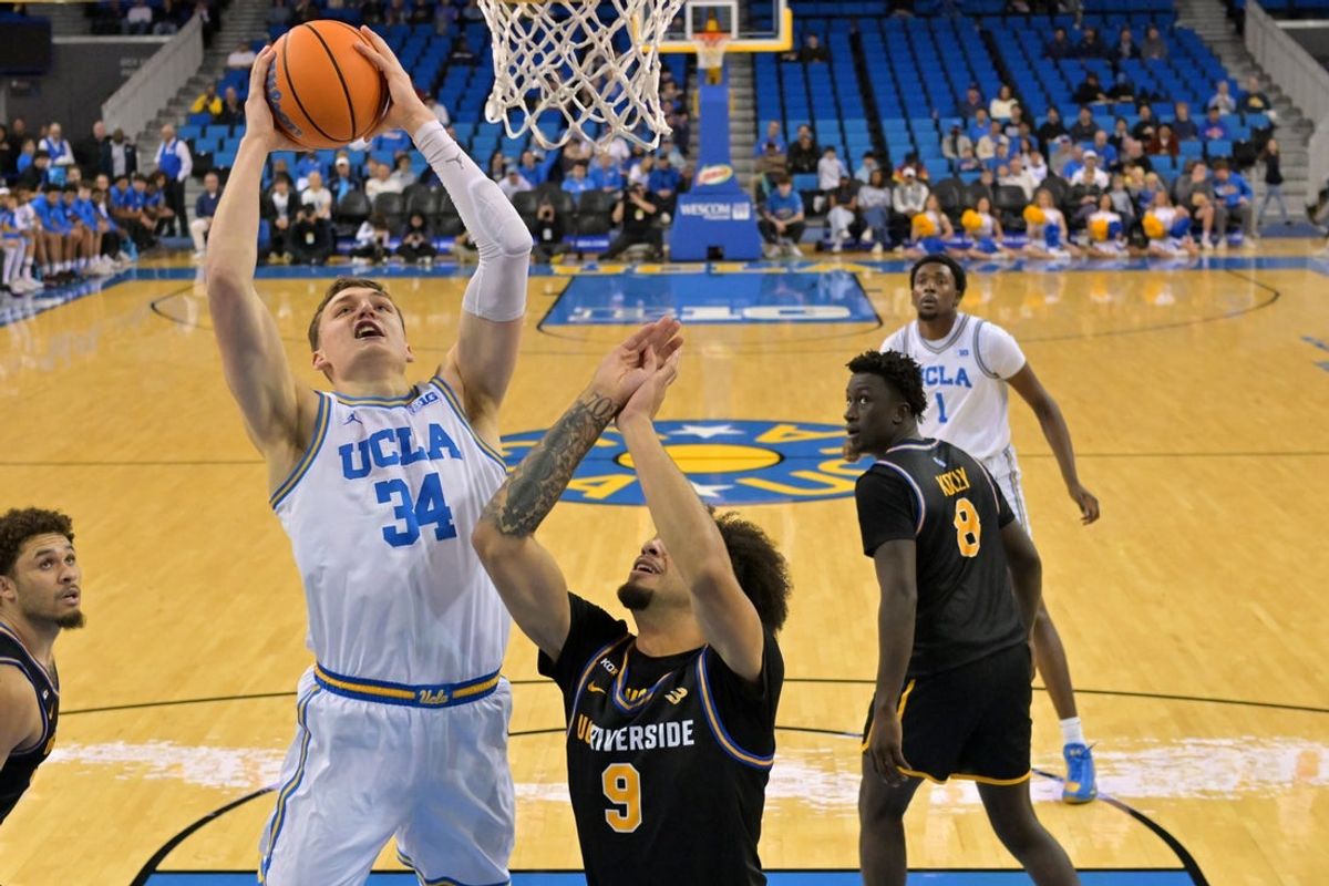 Dec 23, 2025; Los Angeles, California, USA; UCLA Bruins forward Tyler Bilodeau (34) drives past UC Riverside Highlanders forward Osiris Grady (9) in the first half at Pauley Pavilion presented by Wescom Financial. Mandatory Credit: Jayne Kamin-Oncea-Imagn Images
