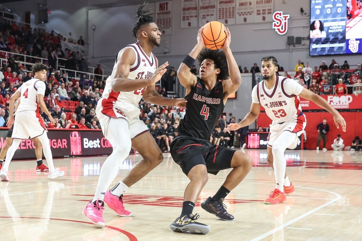 Dec 23, 2025; Queens, New York, USA;  Harvard Crimson guard Robert Hinton (4) looks to post up against St. John's Red Storm forward Bryce Hopkins (23) in the first half at Carnesecca Arena. Mandatory Credit: Wendell Cruz-Imagn Images