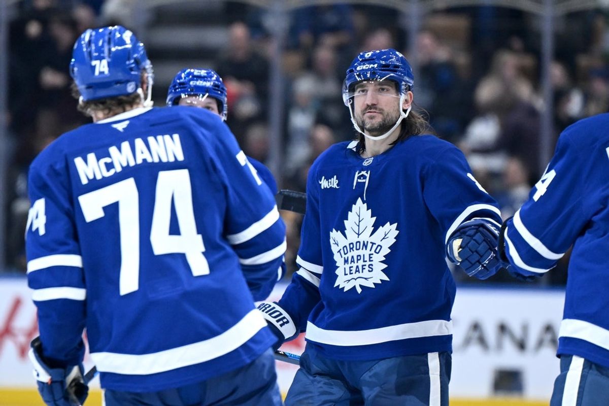 Dec 23, 2025; Toronto, Ontario, CAN;  Toronto Maple Leafs defenseman Chris Tanev (8) greets forward Bobby McMann who scored an empty net goal against the Pittsburgh Penguins in the third period at Scotiabank Arena. Mandatory Credit: Dan Hamilton-Imagn Images