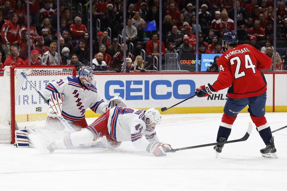 Dec 23, 2025; Washington, District of Columbia, USA; New York Rangers defenseman Vladislav Gavrikov (44) blocks a shot on Rangers goaltender Igor Shesterkin (31) by Washington Capitals center Connor McMichael (24) during the first period at Capital One Arena. Mandatory Credit: Geoff Burke-Imagn Images