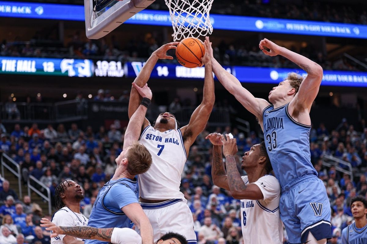 Dec 23, 2025; Newark, New Jersey, USA; Seton Hall Pirates forward Josh Rivera (7) rebounds against Villanova Wildcats forward Matt Hodge (33) during the first half at Prudential Center. Mandatory Credit: Vincent Carchietta-Imagn Images