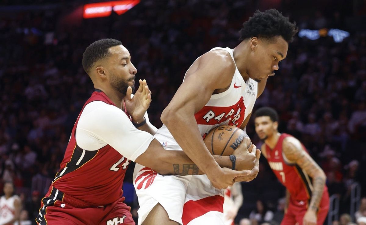 Dec 23, 2025; Miami, Florida, USA;  Miami Heat guard Norman Powell (24) defends Toronto Raptors forward Scottie Barnes (4) during the first half at Kaseya Center. Mandatory Credit: Rhona Wise-Imagn Images