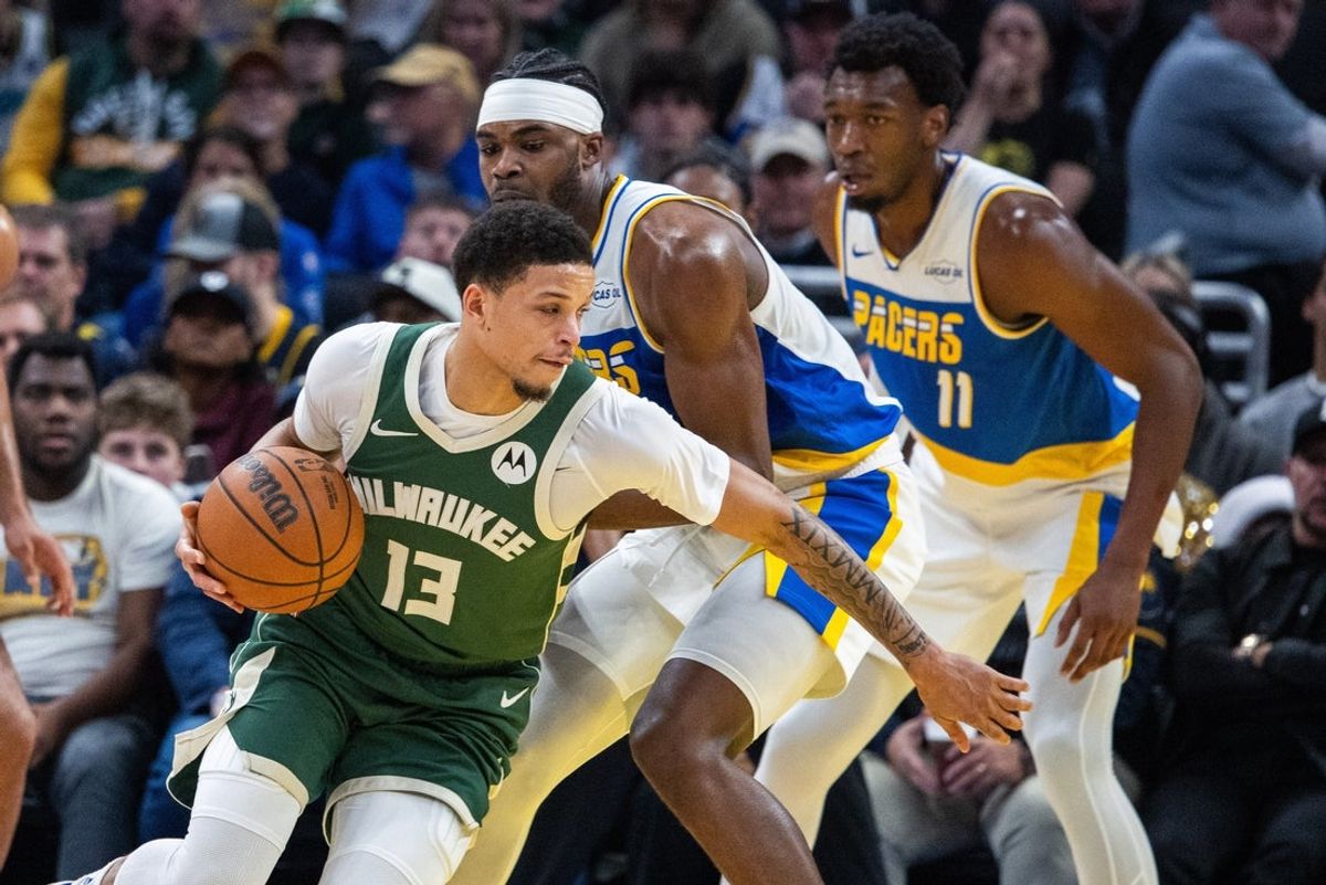 Dec 23, 2025; Indianapolis, Indiana, USA;  Milwaukee Bucks guard Ryan Rollins (13) dribbles the ball while Indiana Pacers forward Jarace Walker (5) defends in the first half at Gainbridge Fieldhouse. Mandatory Credit: Trevor Ruszkowski-Imagn Images