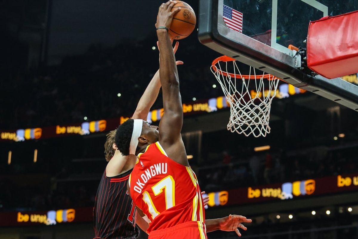 Dec 23, 2025; Atlanta, Georgia, USA; Atlanta Hawks forward Onyeka Okongwu (17) dunks the ball against Chicago Bulls forward Matas Buzelis (14) during the first quarter at State Farm Arena. Mandatory Credit: Jordan Godfree-Imagn Images