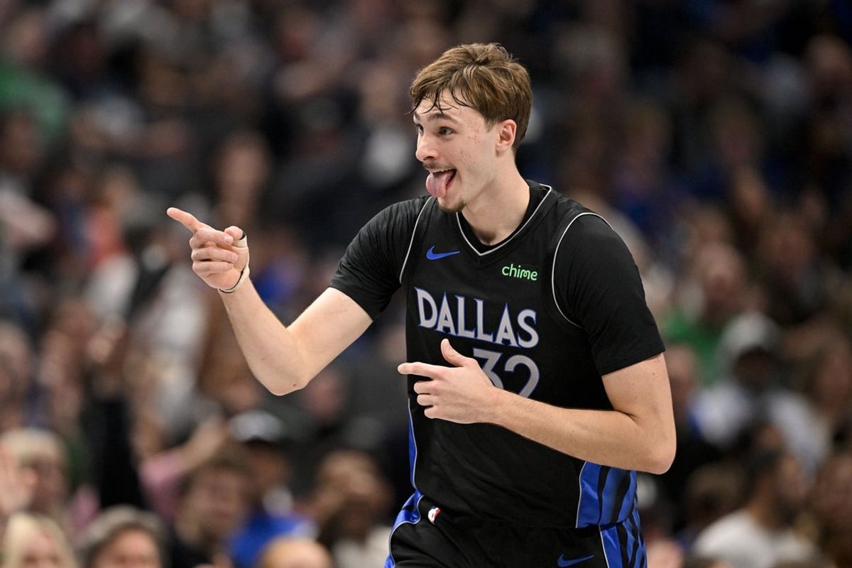 Dec 23, 2025; Dallas, Texas, USA; Dallas Mavericks forward Cooper Flagg (32) points to his team bench as he celebrates scoring against the Denver Nuggets during the second quarter at the American Airlines Center. Mandatory Credit: Jerome Miron-Imagn Images
