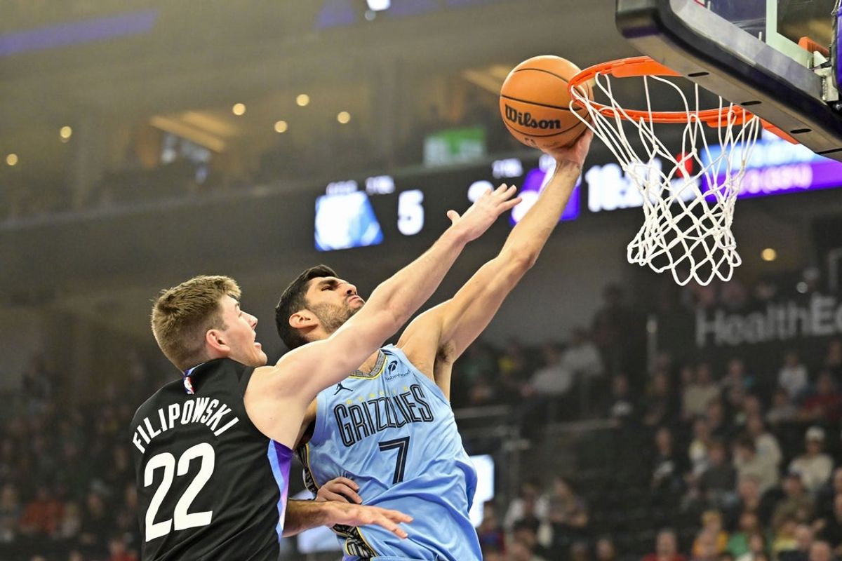 Dec 23, 2025; Salt Lake City, Utah, USA; Memphis Grizzlies forward/center Santi Aldama (7) makes a layup against Utah Jazz center Kyle Filipowski (22) during the first half at Delta Center. Mandatory Credit: Peter Creveling-Imagn Images