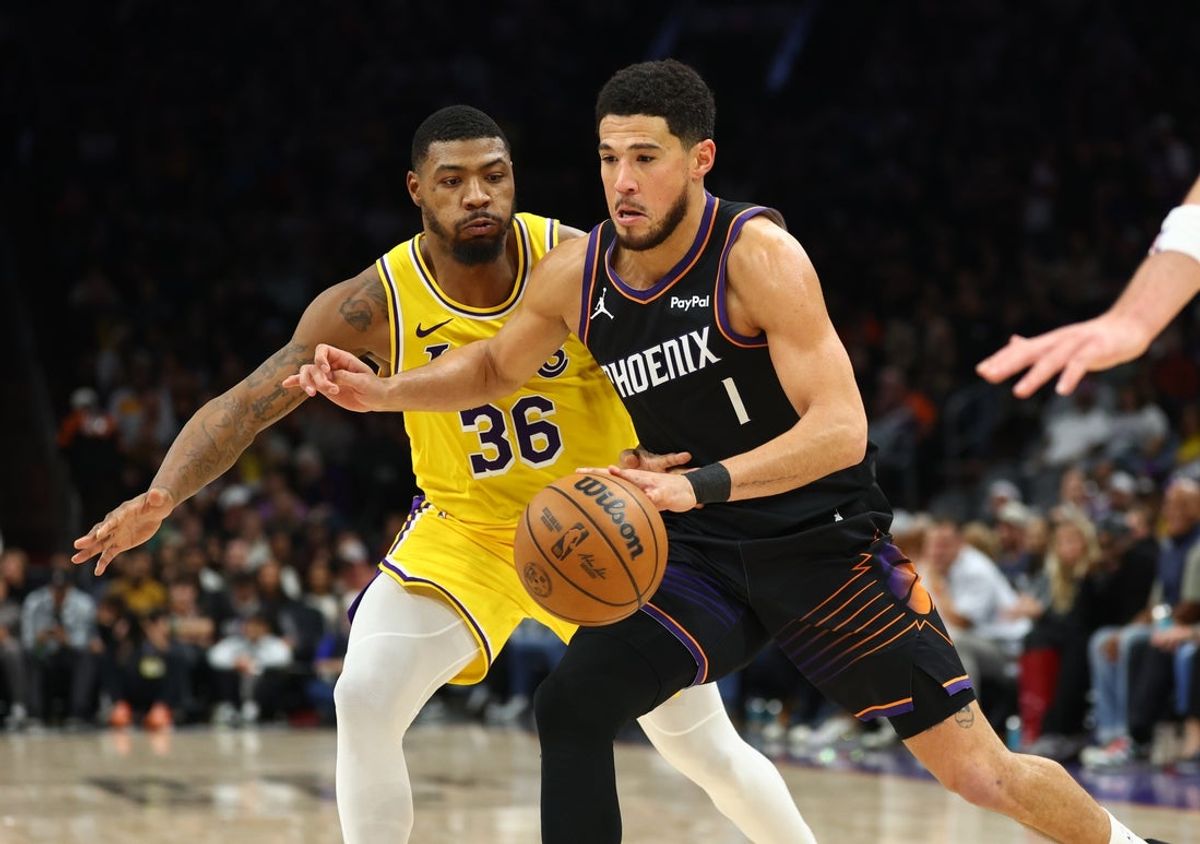 Dec 23, 2025; Phoenix, Arizona, USA; Phoenix Suns guard Devin Booker (1) against Los Angeles Lakers guard Marcus Smart (36) in the first half at Mortgage Matchup Center. Mandatory Credit: Mark J. Rebilas-Imagn Images