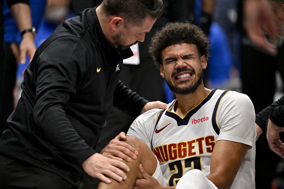 Dec 23, 2025; Dallas, Texas, USA; A Denver Nuggets trainer checks on forward Cameron Johnson (23) during the second half against the Dallas Mavericks at the American Airlines Center. Mandatory Credit: Jerome Miron-Imagn Images