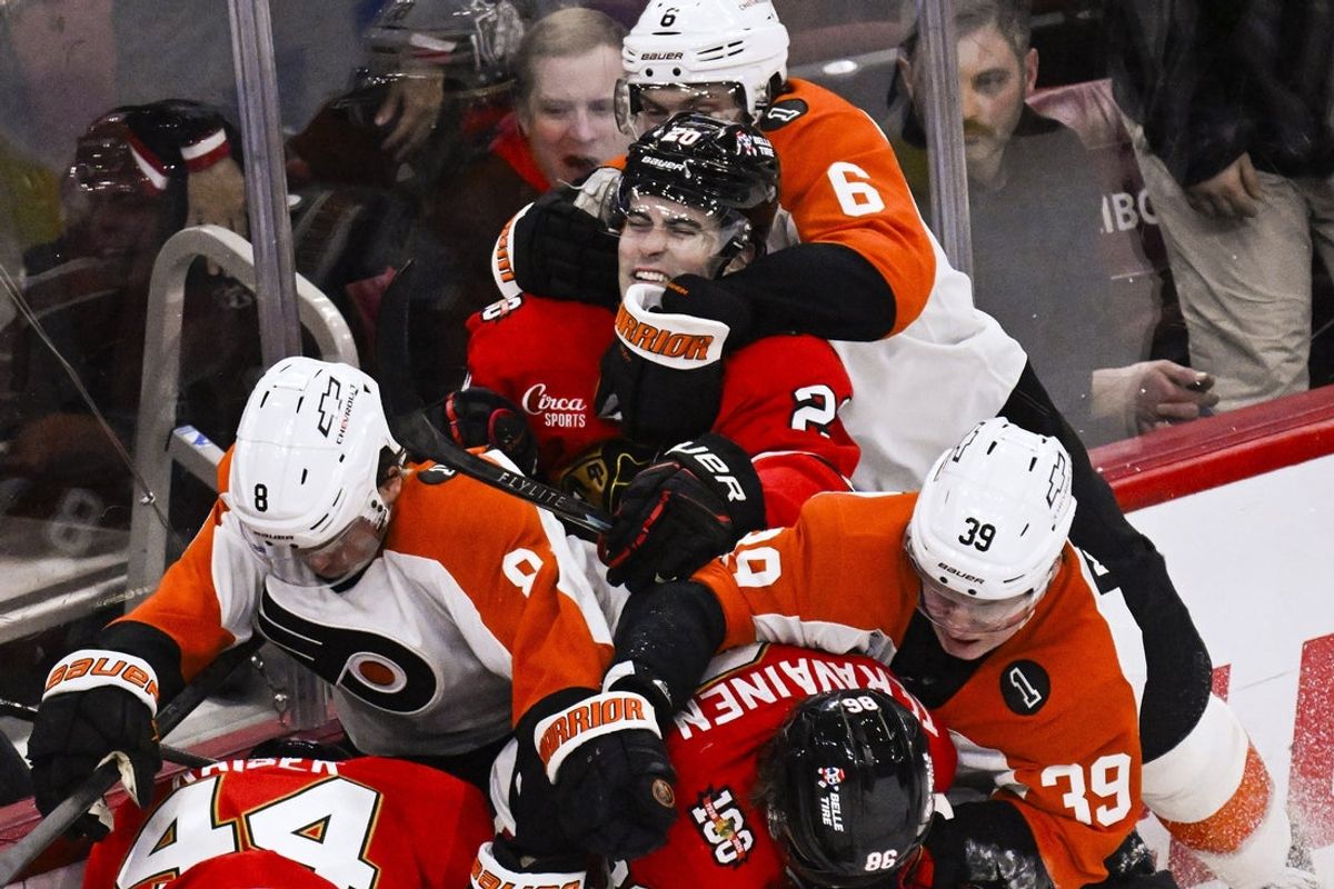 Dec 23, 2025; Chicago, Illinois, USA;  Philadelphia Flyers defenseman Travis Sanheim (6) and Chicago Blackhawks center Ryan Greene (20) fight during the second period at United Center. Mandatory Credit: Matt Marton-Imagn Images