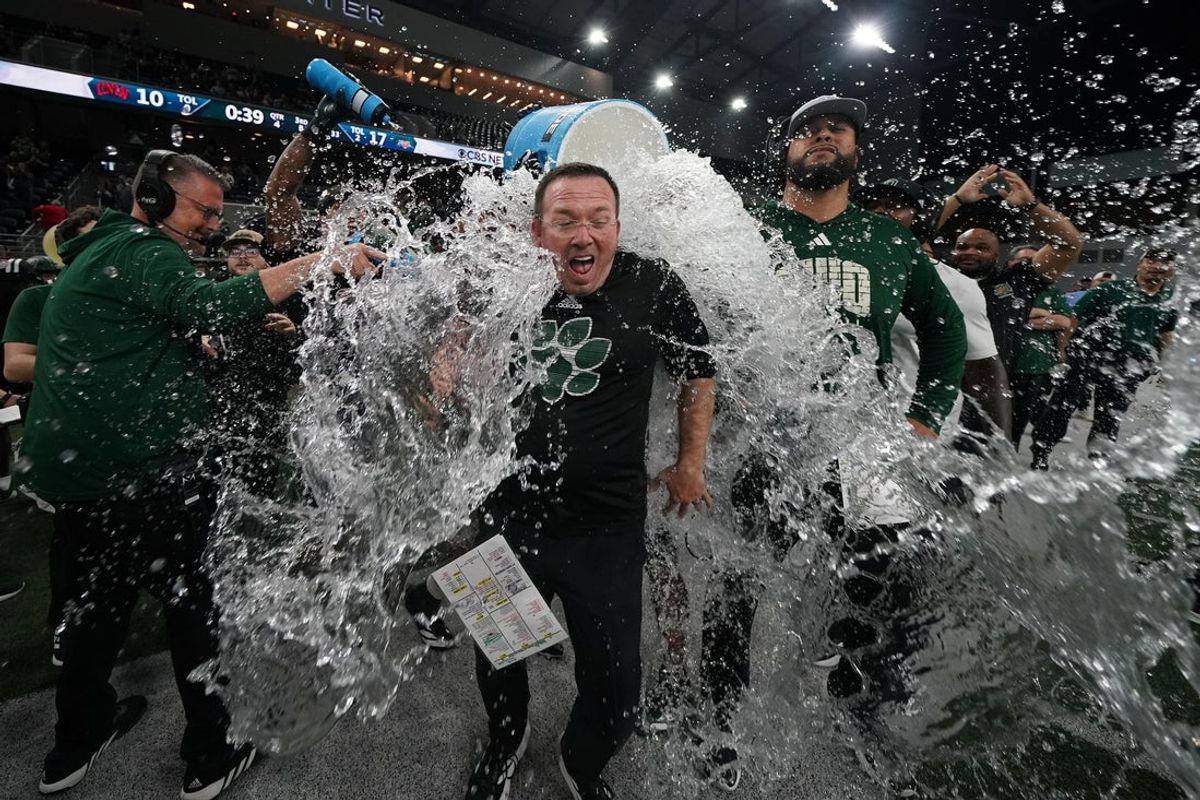 Dec 23, 2025; Frisco, TX, USA;  Ohio Bobcats interim head coach John Hauser is doused with water following a game against the UNLV Rebels at the Ford Center at The Star. Mandatory Credit: Raymond Carlin III-Imagn Images