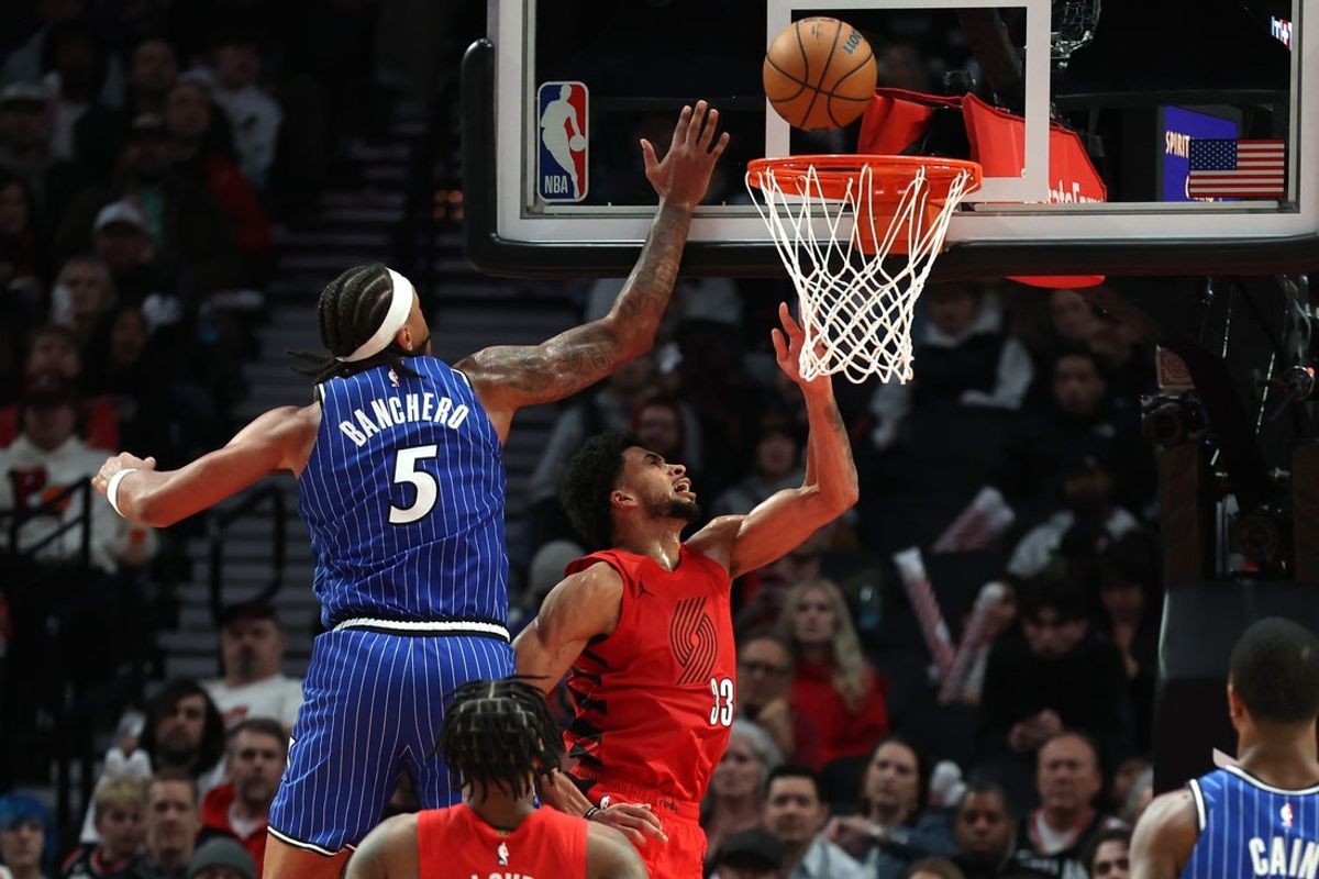 Dec 23, 2025; Portland, Oregon, USA;  Portland Trail Blazers forward Toumani Camara (33) shoots the ball under the arms of Orlando Magic forward Paolo Banchero (5) during the second half at Moda Center. Mandatory Credit: Jaime Valdez-Imagn Images