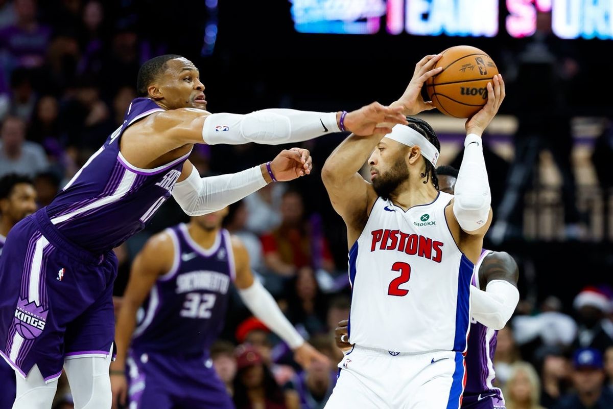 Dec 23, 2025; Sacramento, California, USA; Detroit Pistons guard Cade Cunningham (2) is fouled by Sacramento Kings guard Russell Westbrook (18) during the third quarter at Golden 1 Center. Mandatory Credit: Sergio Estrada-Imagn Images
