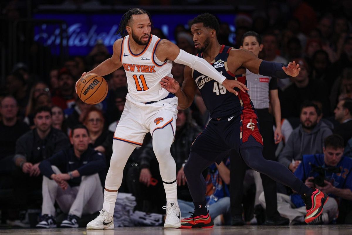 Dec 25, 2025; New York, New York, USA; New York Knicks guard Jalen Brunson (11) is guarded by Cleveland Cavaliers guard Donovan Mitchell (45) during the first half at Madison Square Garden. Mandatory Credit: Vincent Carchietta-Imagn Images