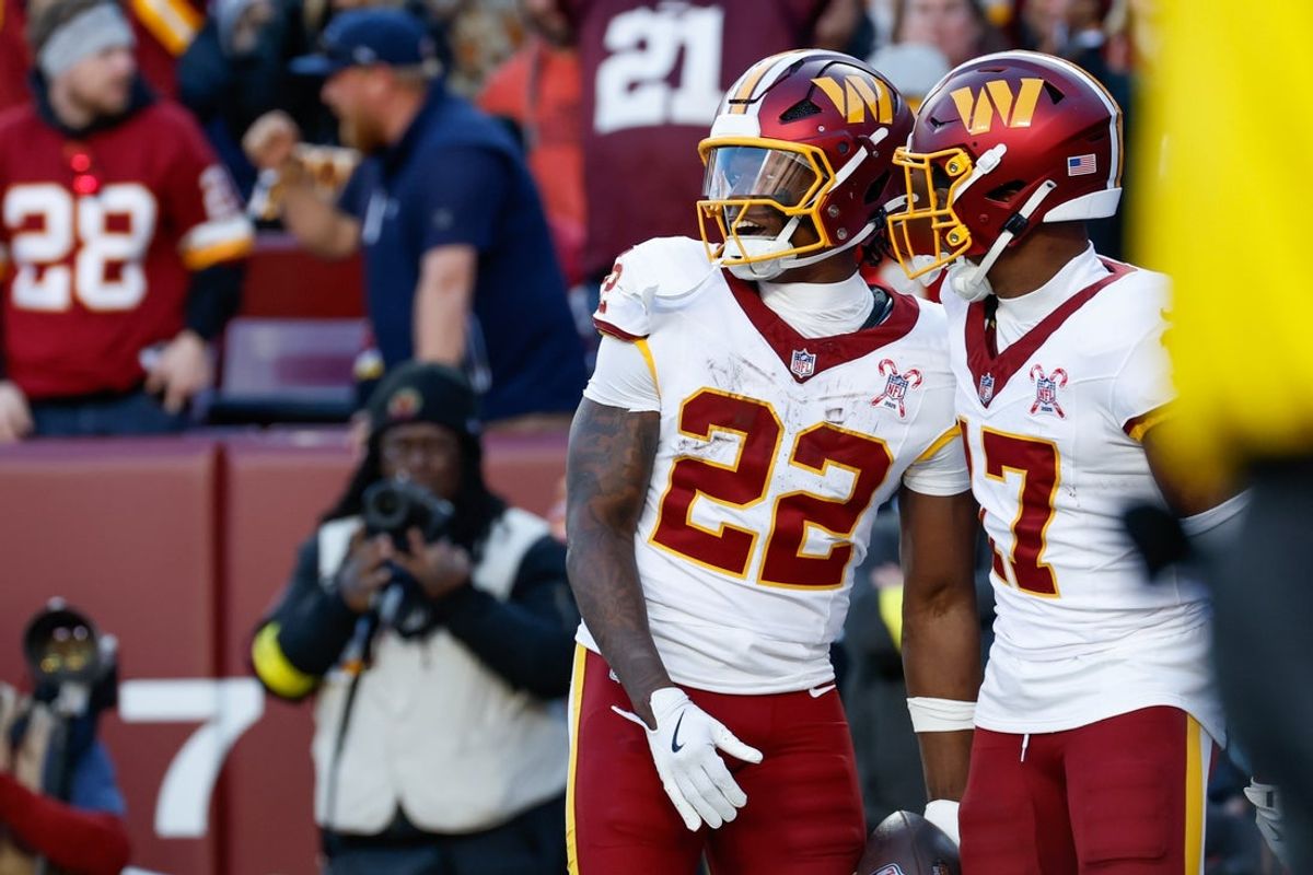 Dec 25, 2025; Landover, Maryland, USA; Washington Commanders running back Jacory Croskey-Merritt (22) celebrates after scoring a touchdown against the Dallas Cowboys with wide receiver Terry McLaurin (17) in the second quarter at Northwest Stadium. Mandatory Credit: Amber Searls-Imagn Images