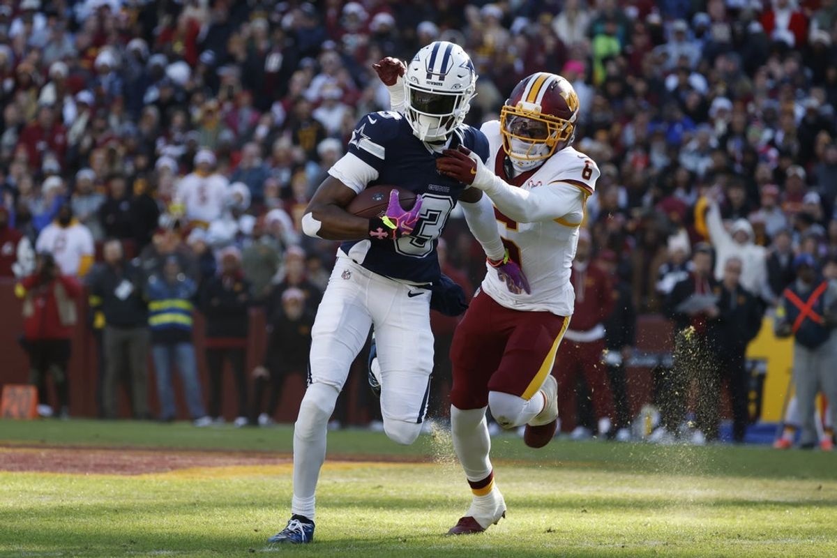 Dec 25, 2025; Landover, Maryland, USA; Dallas Cowboys wide receiver George Pickens (3) carries the ball as Washington Commanders cornerback Noah Igbinoghene (6) defends during the first half at Northwest Stadium. Mandatory Credit: Amber Searls-Imagn Images