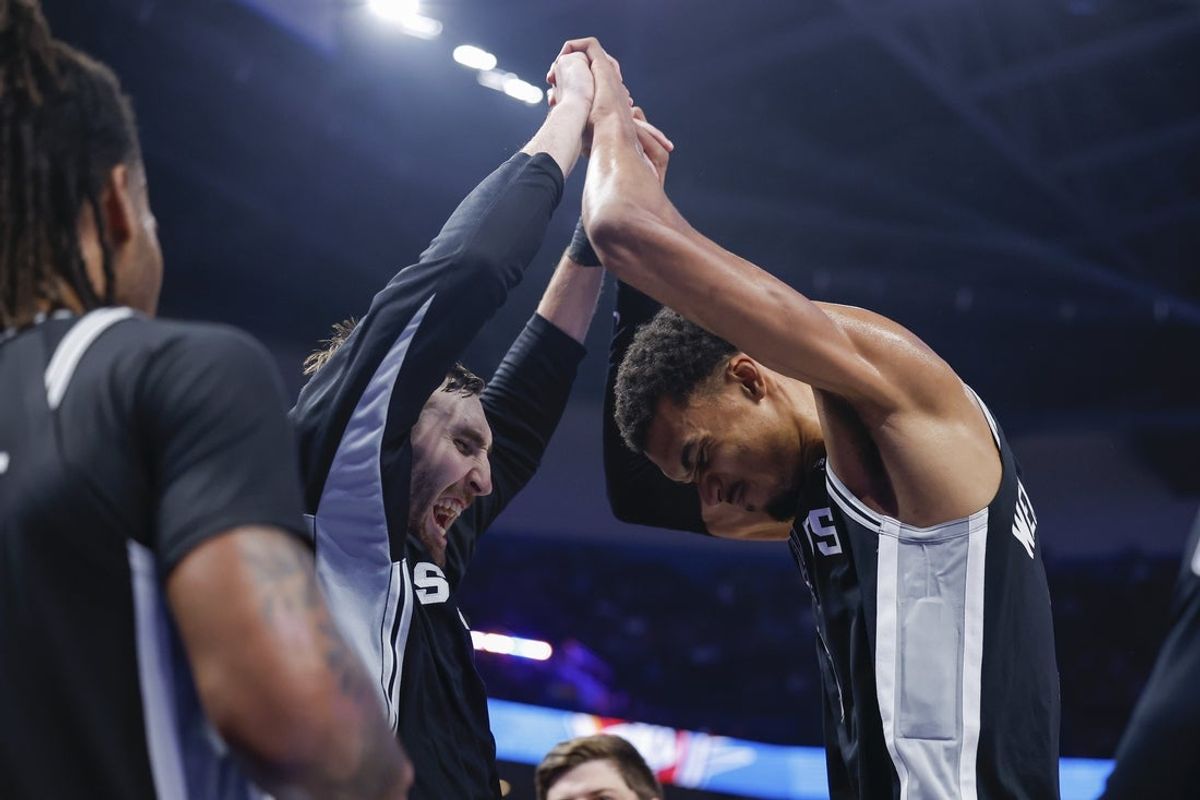 Dec 25, 2025; Oklahoma City, Oklahoma, USA; San Antonio Spurs forward Victor Wembanyama (1) and center Luke Kornet (7) celebrate at the end of the fourth quarter against the Oklahoma City Thunder at Paycom Center. Mandatory Credit: Alonzo Adams-Imagn Images