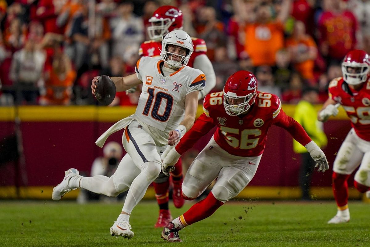 Dec 25, 2025; Kansas City, Missouri, USA; Denver Broncos quarterback Bo Nix (10) runs against Kansas City Chiefs defensive end George Karlaftis (56) during the second quarter at GEHA Field at Arrowhead Stadium. Mandatory Credit: Jay Biggerstaff-Imagn Images